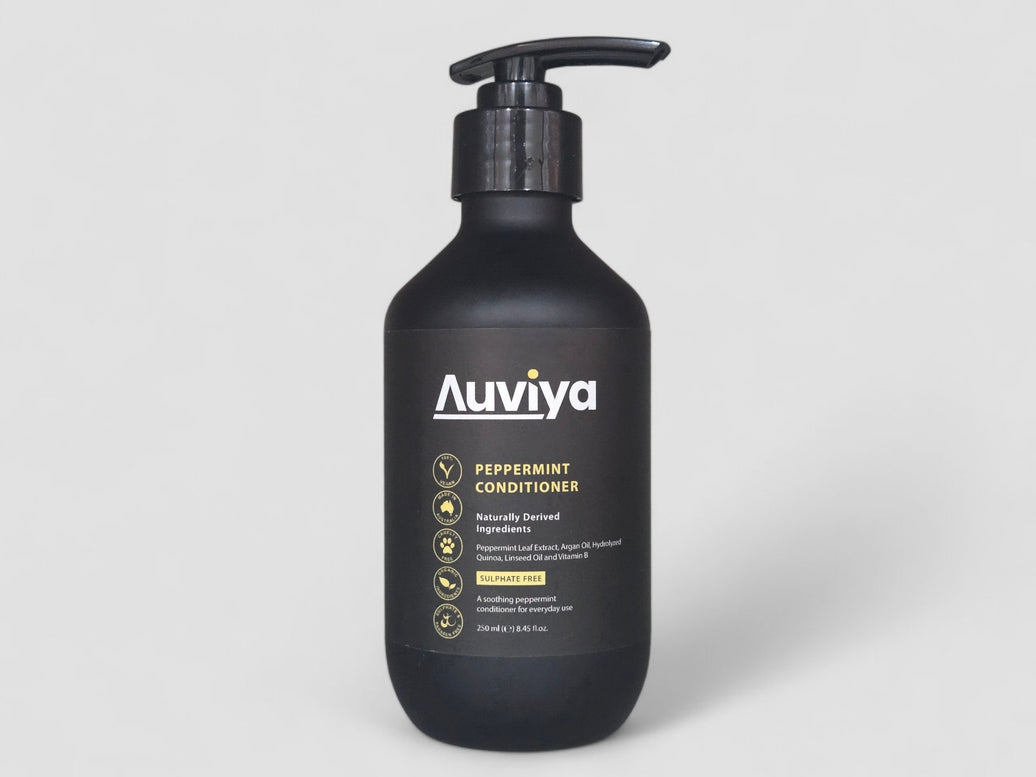 Black bottle of Auviya peppermint conditioner on a light gray background