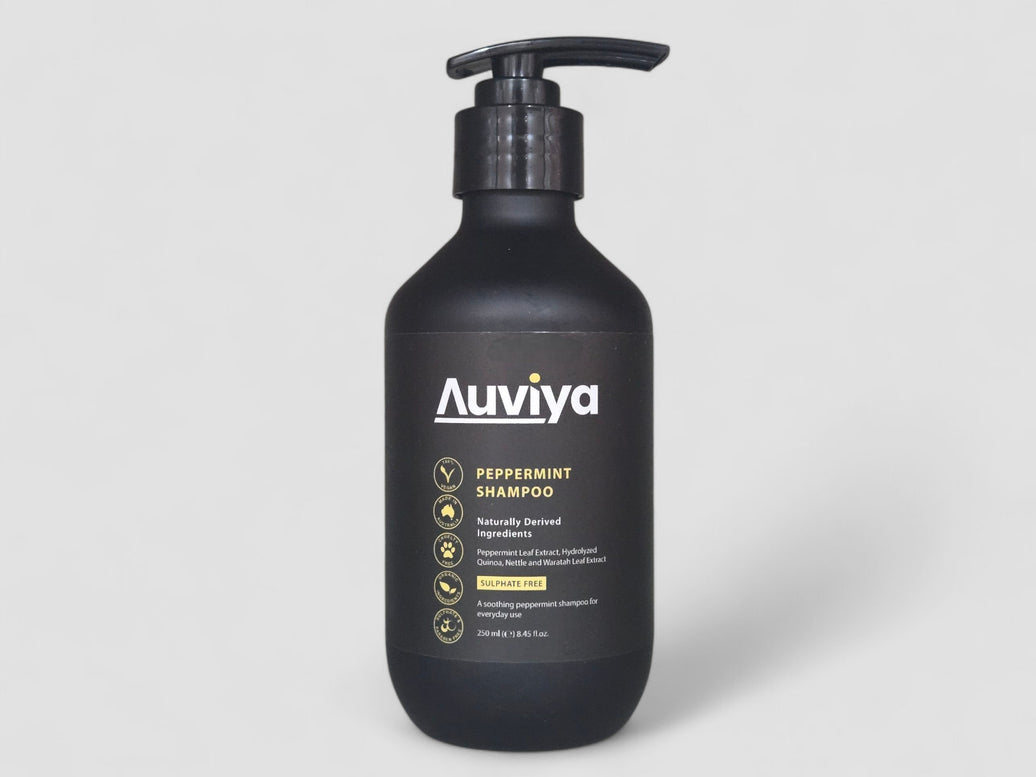 Black shampoo bottle with pump labeled 'Auviya' on a light gray background