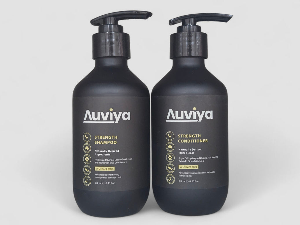 Two Auviya shampoo and conditioner bottles on a white background