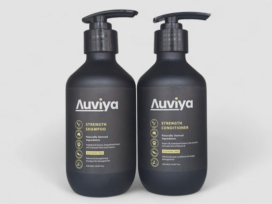 Two Auviya shampoo and conditioner bottles on a white background