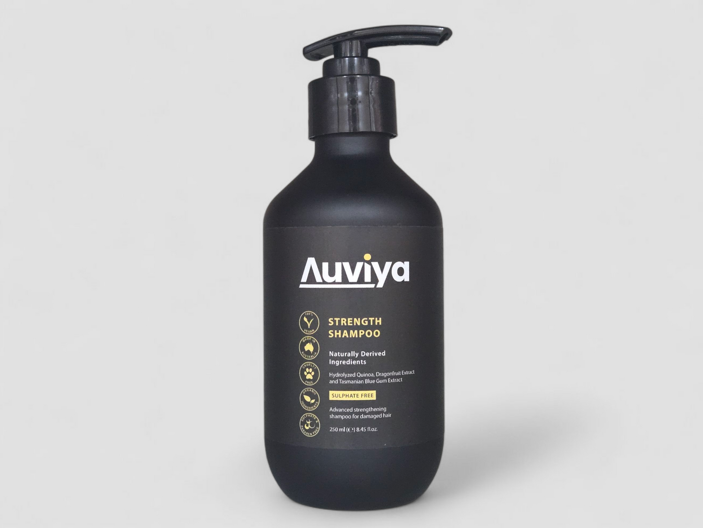 Black shampoo bottle with 'Auviya' label on a light gray background