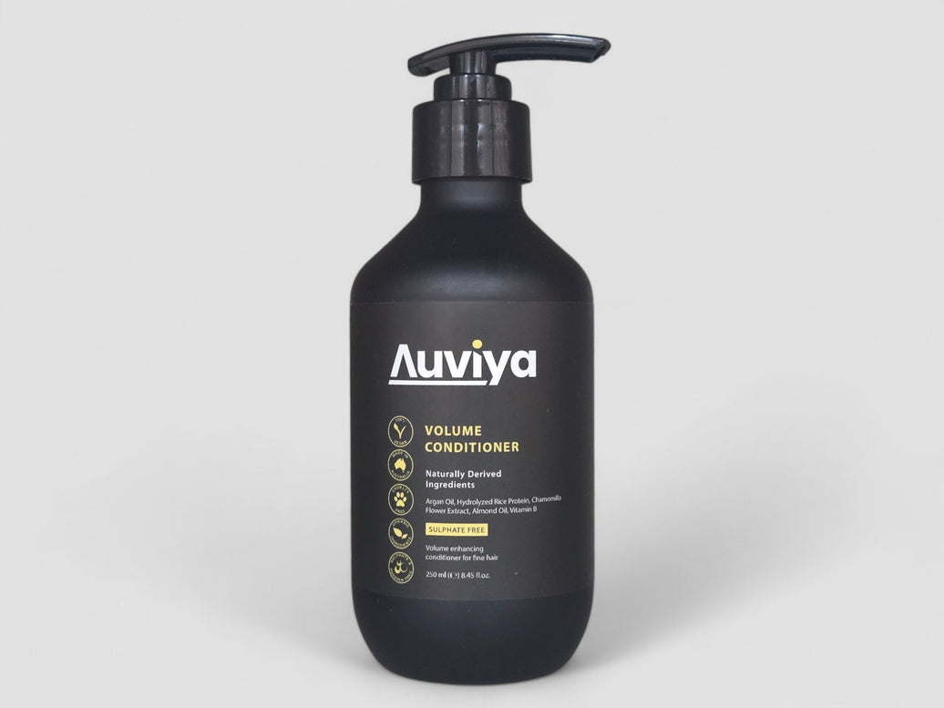 Black bottle of Auviya Volume Conditioner on a light gray background