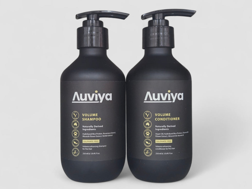 Two Auviya shampoo and conditioner bottles on a white background