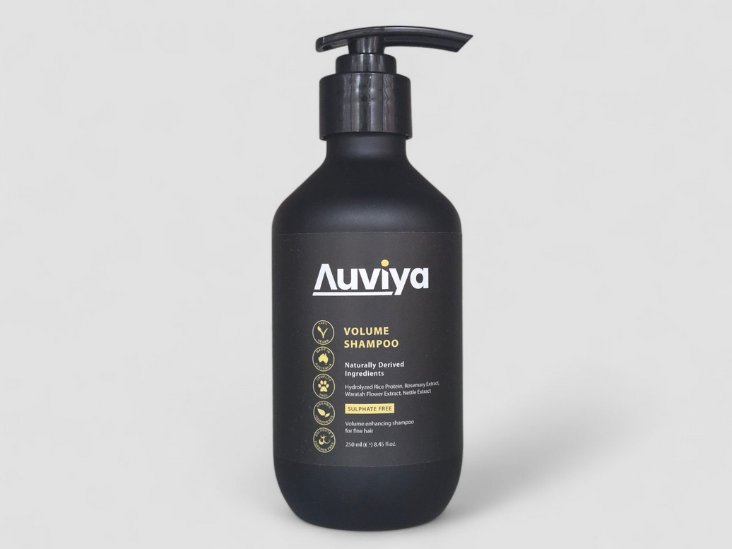 Black shampoo bottle with 'Auviviya' branding on a gray background